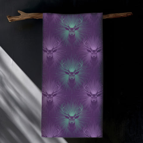 Set of four purple dining napkins featuring alternating teal and violet stag heads with radiating sunburst patterns, sized 18x18 inches.